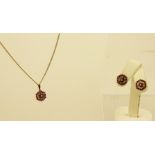 A PENDANT AND STUD EARRINGS SUITE, each having rubies and diamonds in a hexagon, the pendant on a