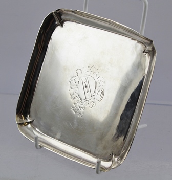 AN 18TH CENTURY SQUARE SILVER CARD TRAY, having raised rim on applied bracket feet, engraved