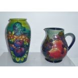 A MOORCROFT BALUSTER JUG, "Finches and Fruit" pattern, 15cm high, together with a SIMILAR