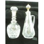 ALBERT EDWARD JONES A MODERN SILVER MOUNTED CUT GLASS RING NECK DECANTER, having star cut base and