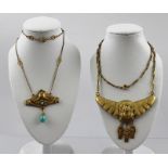 TWO EARLY 20TH CENTURY EGYPTIAN REVIVAL GILT METAL NECKLACES, each with mask motifs and pendants