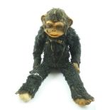 AN EARLY TO MID 20TH CENTURY SOFT TOY CHIMPANZEE, with moulded rubber face and glass eyes, 50cm high