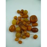 A SELECTION OF AMBER BEADS of varying sizes and shapes