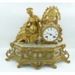 A FRENCH ROCOCO DESIGN GILDED SPELTER MANTEL CLOCK, circa 1900, mounted with a woman of fashion