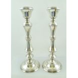 W.I. BROADWAY & CO. A PAIR OF 20TH CENTURY SILVER CANDLESTICKS of early Georgian design,