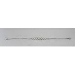 A RHODIUM FINISHED WHITE GOLD COLOURED METAL MOUNTED DIAMOND BRACELET, set with fifty graduated