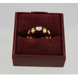 A DIAMOND AND RED ENAMEL MOUNTED FOREIGN GOLD COLOURED METAL ETERNITY RING, the top set with a heart