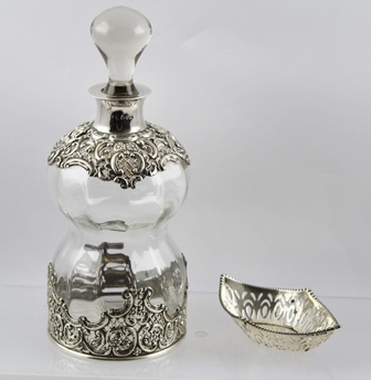 AN EDWARDIAN SILVER MOUNTED WAISTED GLASS DECANTER Chester 1904 including stopper 24cm high,