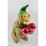 A 1950'S/60'S MARACAS MONKEY, in the manner of Max Carl, wearing green felt hat, holding red and