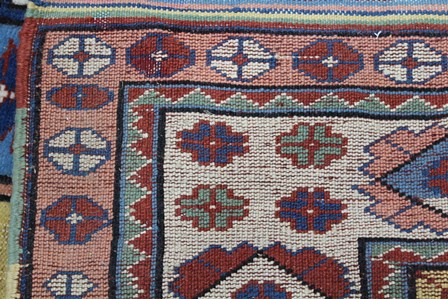 A TURKISH ELMAZ RUG having central yellow field with stylized geometric designs in blue, green, - Image 4 of 4