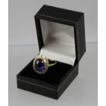 AN OVAL CABOCHON SAPPHIRE AND DIAMOND DRESS RING, the rub over central stone bordered by twenty-