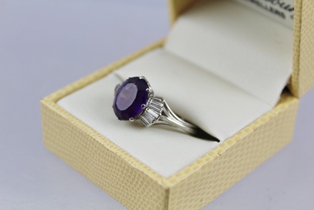 AN AMETHYST AND DIAMOND CLUSTER RING having central oval step cut amethyst, approx 3.95ct with - Image 3 of 4