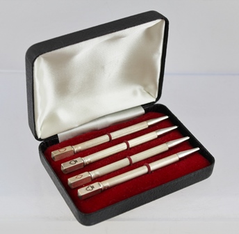 A SET OF FOUR STERLING SILVER BRIDGE PENCILS, each with a suit symbol to the top, cased