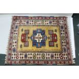 A TURKISH ELMAZ RUG having central yellow field with stylized geometric designs in blue, green,