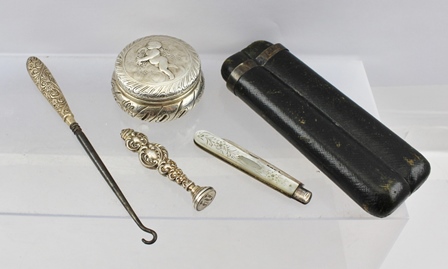 A 19TH CENTURY CONTINENTAL WHITE METAL BOX, the cover embossed with cherub decoration, various