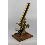 A LATE VICTORIAN LACQUERED BRASS MONOCULAR MICROSCOPE, raised on mahogany stand