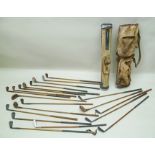 TWO EARLY 20TH CENTURY GOLF BAGS, mixed hickory & wooden shafted golf clubs, includes drivers,