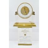 A 1980'S "GOLDEN EAGLE COMMEMORATIVE CLOCK" GILT BRASS AND GLASS MANTEL TIMEPIECE, having a Roman