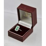 A RHODIUM FINISHED WHITE GOLD COLOURED METAL DECO STYLE EMERALD AND DIAMOND SET "TABLET" RING,