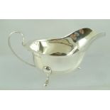 EDWARD VINER LTD. A CHIPPENDALE STYLE SILVER SAUCE BOAT, having cut shaped rim, plain up-scrolled