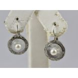 A PAIR OF PEARL AND DIAMOND SET RHODIUM FINISHED WHITE GOLD COLOURED METAL EARRINGS, each having a