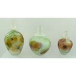 A COLLECTION OF THREE FROSTED ART GLASS SCENT BOTTLES with floral decoration, complete with