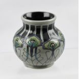 A MOORCROFT CERAMIC VASE, designed by Nicola Slaney, tube lined and hand painted in the "Peacock