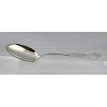 A FOREIGN SILVER COLOURED METAL PRESENTATION BASTING SPOON, the handle cast with scrolls and