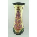 A MOORCROFT "FOXGLOVE" PATTERN VASE, having hand painted and tube lined decoration, of waisted form,