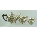 JOSEPH GLOSTER AN EDWARDIAN SILVER THREE PIECE BACHELOR TEA SET of Georgian design, repousse