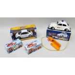 A BATTERY OPERATED REMOTE CONTROL VW POLICE CAR in original vendor's box, a DIE-CAST METAL (with