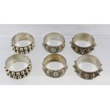 THREE PAIRS OF ASIAN SILVER NAPKIN RINGS with decorative designs