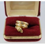 A CONTEMPORARY TRI-COLOUR GOLD COLOURED METAL SNAKE RING, having sapphire and diamond multi-gem