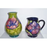 TWO PIECES OF MOORCROFT "Anemone" pattern, comprising a jug on blue ground, 15cm high, and a squat