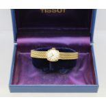 A "TISSOT" 9CT GOLD CASED LADY'S WRIST WATCH with 9ct gold strap, 17-jewel movement, in presentation