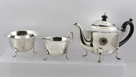 WILLIAMS (BIRMINGHAM) LTD. A THREE-PIECE SILVER TEA SET, each having cut shaped rim, plain belly and