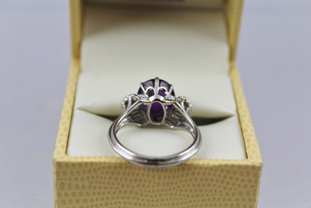 AN AMETHYST AND DIAMOND CLUSTER RING having central oval step cut amethyst, approx 3.95ct with - Image 4 of 4