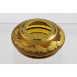 A BOHEMIAN GLASS ASHTRAY, having amber glass gilded with a rural landscape, indistinctly signed,