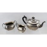 AN "ASPREY" SILVER PLATED THREE-PIECE TEA SET of Georgian fluted design, comprising teapot (