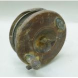 A WOODEN SEA REEL with brass mounts, 13cm diameter