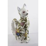 A 20TH CENTURY ITALIAN MAJOLICA SEATED CAT ORNAMENT, having hand painted flower head and acanthus