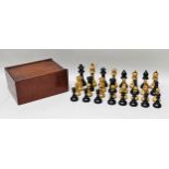 A LATE VICTORIAN BOXWOOD AND EBONY 'STAUNTON' DESIGN CHESS SET in mahogany box, 10cm high