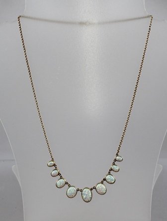 A 20TH CENTURY GOLD COLOURED METAL OPAL NECKLET, having nine oval cabochon stones, each in rub