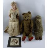 AN EARLY 20TH CENTURY MOHAIR TEDDY BEAR, 50cm high together with an EARLY WAX HEAD DOLL in early