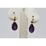 A PAIR OF AMETHYST DROP EARRINGS with pear shaped stones, set in 9ct gold on pierced ear wires