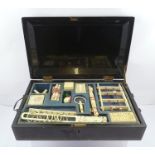 A 19TH CENTURY CHINESE PUZZLE COMPENDIUM contained within a black lacquer hinged lidded box with