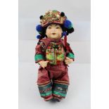 A CHINESE COLLECTOR'S DOLL wearing a richly embroidered costume and beaded headdress, 34cm high