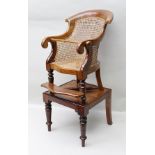 A LATE VICTORIAN CHILD'S BEECH FRAMED SCROLLING ARM HIGH CHAIR having split cane upholstered back