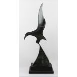 A 20TH CENTURY BRONZE SCULPTURE OF A STYLISED BIRD IN FLIGHT, partial green patination, raised on an