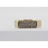 A 9CT GOLD UNISEX DIAMOND FINGER RING having a rectangular head set with 60 small diamonds, on a